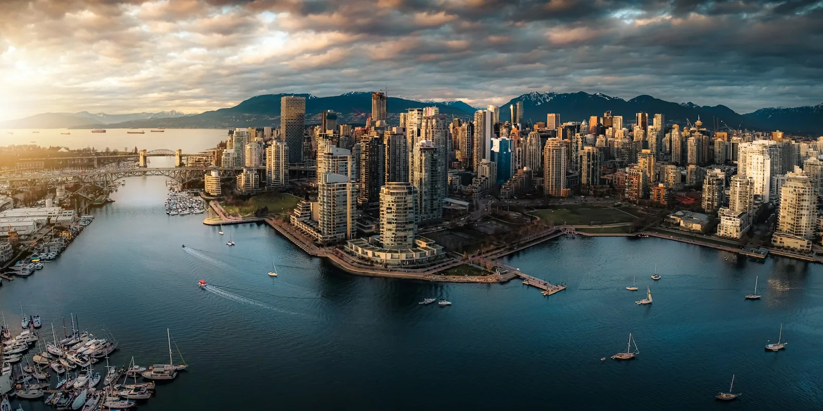 Vancouver skyline, mountains and the False Creek waterfront at golden hour